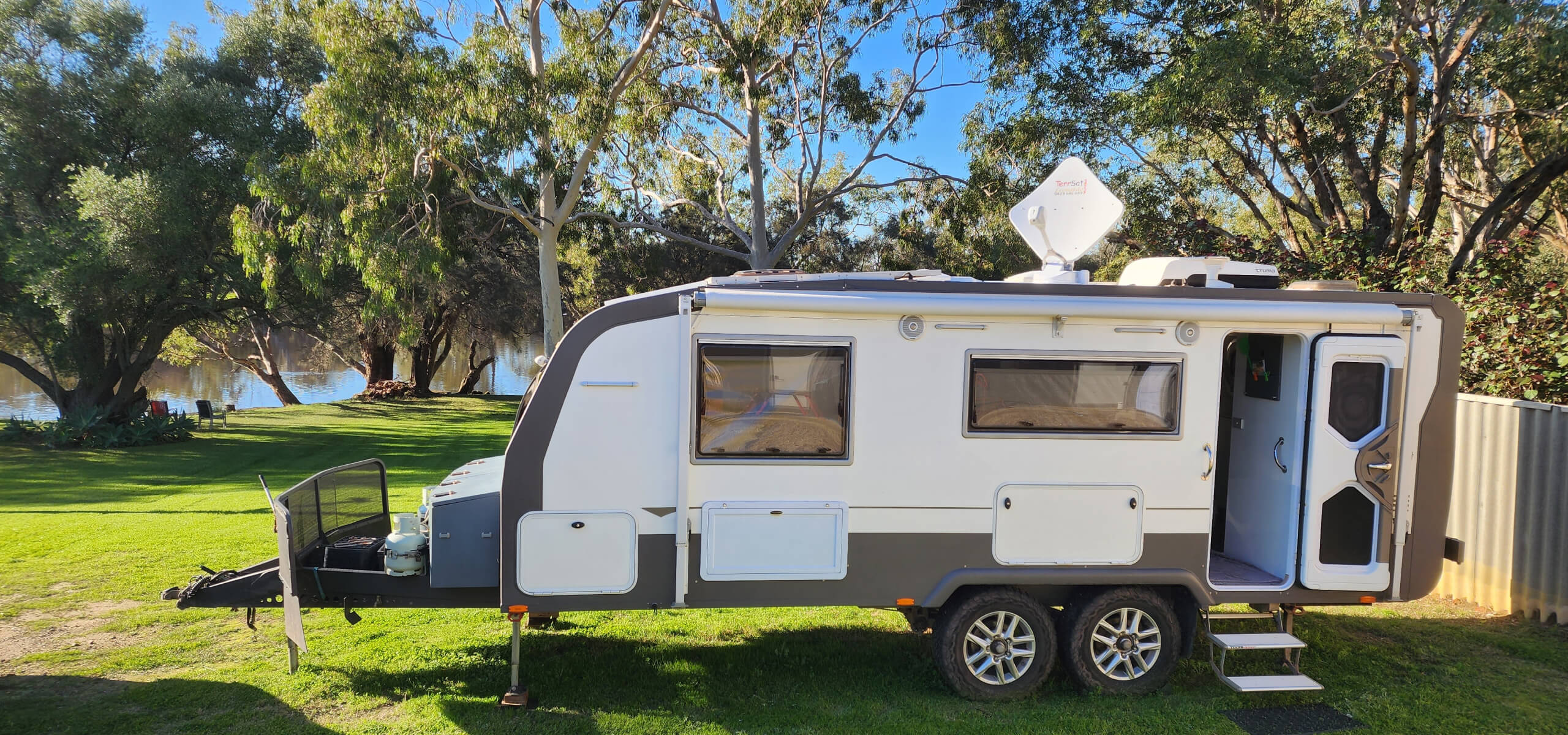 A photo of a caravan with a TerrSat satellite on top.